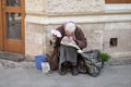 Elderly woman in downtown. Old woman selling flowers in Lviv, Ukraine