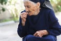 Elderly woman eating cherry Royalty Free Stock Photo