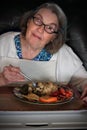 Elderly woman eating lunch