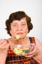 Elderly woman eating salad Royalty Free Stock Photo