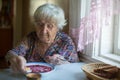 An elderly woman eating soup borsch sitting at the table Royalty Free Stock Photo