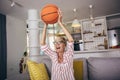 Woman emotionally watching basketball on tv and celebrating victory at home