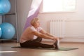 An elderly woman is engaged in stretching at the gym. Royalty Free Stock Photo
