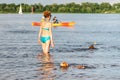 Elderly woman enjoying outdoor activities playing ball in river swimming with her cute dog Dachshund breed. concept pets, love for Royalty Free Stock Photo