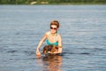 Elderly woman enjoying outdoor activities playing ball in river swimming with her cute dog Dachshund breed. concept pets, love for Royalty Free Stock Photo