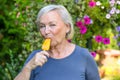 Elderly woman enjoying a refreshing iced lolly