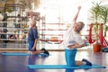 Elderly woman exercising in fitness center. Royalty Free Stock Photo