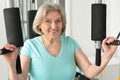 Elderly woman exercising in gym Royalty Free Stock Photo