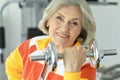 Elderly woman exercising in gym Royalty Free Stock Photo