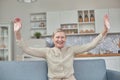 An elderly woman experiences the joy of being at home with her arms wide open. Happy pensioner concept Royalty Free Stock Photo