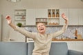 An elderly woman experiences the joy of being at home with her arms wide open. Happy pensioner concept Royalty Free Stock Photo