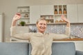 An elderly woman experiences the joy of being at home with her arms wide open. Happy pensioner concept Royalty Free Stock Photo