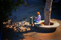 An elderly woman feeding pigeons