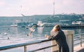 The elderly woman feeds birds