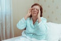 Elderly woman feel sick at home in bedroom. Royalty Free Stock Photo