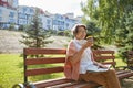 Elderly woman feeling satisfied drinking coffee having rest in city park Royalty Free Stock Photo