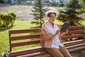 Elderly woman feeling satisfied drinking coffee having rest in city park Royalty Free Stock Photo