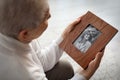 Elderly woman with framed family portrait Royalty Free Stock Photo