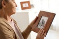 Elderly woman with framed family portrait Royalty Free Stock Photo