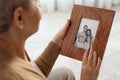 Elderly woman with framed family portrait Royalty Free Stock Photo