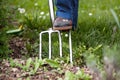 Elderly woman in the garden with pitchfork