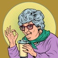 elderly woman granny drinks a coke drink, ok gesture