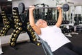 elderly woman with gray hair plays sports in gym. Active healthy lifestyle, pensioner, senior concept. Rehabilitation