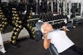 elderly woman with gray hair plays sports in gym. Active healthy lifestyle, pensioner, senior concept. Rehabilitation