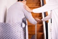 Elderly woman hands holding sticks while walking up stair at home,Caregiving take care and support,Self-Care for Family Caregivers