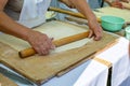 Elderly woman hands rolling out dough with rolling pin. Concept - benefits of cooking at home, active life in old age. Royalty Free Stock Photo