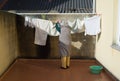 Elderly woman hanging out the washing Royalty Free Stock Photo