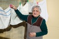 Elderly woman hanging out the washing Royalty Free Stock Photo