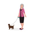 Elderly woman with happy smile walking with small brown dog on leash