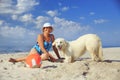 Elderly woman with her golder retriever on a sea Royalty Free Stock Photo