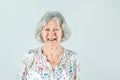 Elderly woman in her 80& x27;s with Gray hair isolated on a white backdrop smiling and laughing and happy. Royalty Free Stock Photo