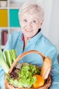 Elderly woman holding basket Royalty Free Stock Photo