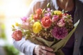 The elderly woman is holding a beautiful bouquet of flowers in her hands. Mother's Day. Royalty Free Stock Photo