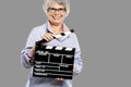 Elderly woman holding a clapboard Royalty Free Stock Photo