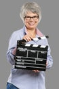 Elderly woman holding a clapboard