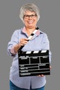 Elderly woman holding a clapboard Royalty Free Stock Photo