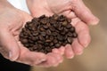 Elderly woman holding coffee beans Royalty Free Stock Photo