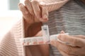 Elderly woman holding container with different pills, closeup