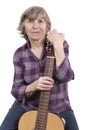 Elderly woman holding a guitar