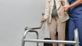 Elderly woman holding on handrail with caregiver Royalty Free Stock Photo