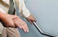 Elderly woman holding on handrail with caregiver Royalty Free Stock Photo