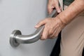 Elderly woman holding on handrail for safety walk steps Royalty Free Stock Photo