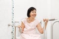 Elderly woman holding on handrail in toilet. Royalty Free Stock Photo