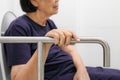 Elderly woman holding on handrail in toilet. Royalty Free Stock Photo