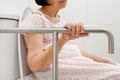 Elderly woman holding on handrail in toilet. Royalty Free Stock Photo