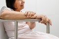 Elderly woman holding on handrail in toilet. Royalty Free Stock Photo